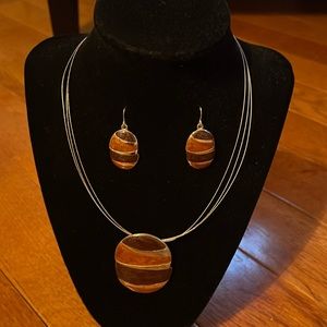 Gold plated necklace with light, dark brown and gold pendant.